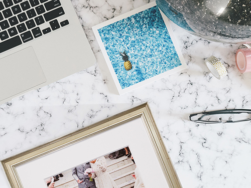 Print-Frame-500 framed print on table next to laptop