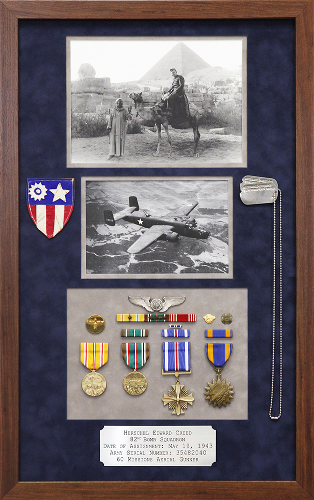 Custom framed arrangement of military medals, photographs, and customized nameplate framed in mahogany frame with navy blue suede mat Hall of Frames Arizona