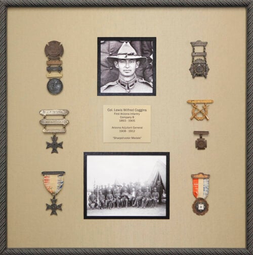 Custom framed arrangement of military medals, photographs, and customized nameplate framed in scrolled black frame with taupe silk mat Hall of Frames Arizona