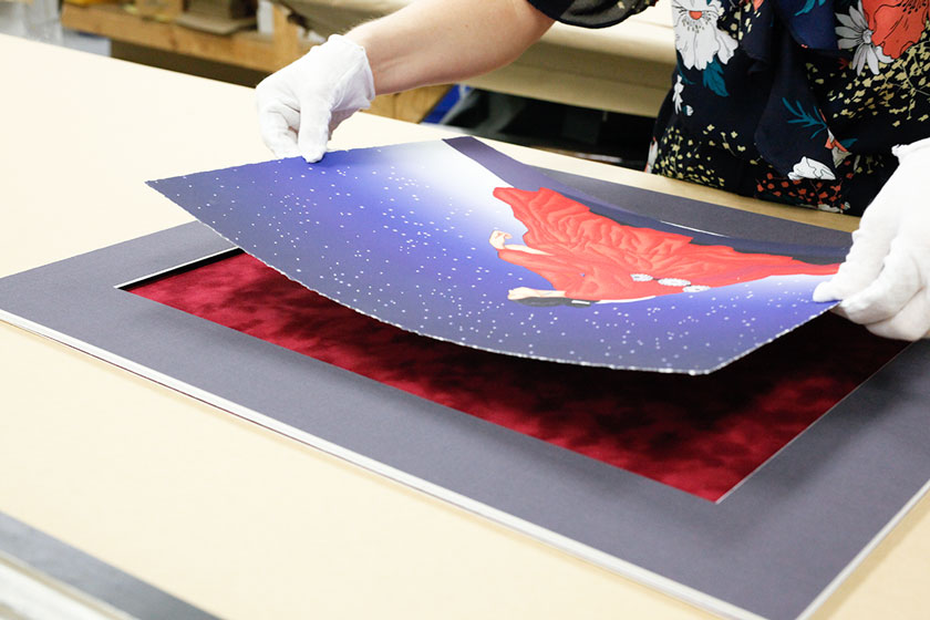 Art being placed on its mat during the framing process Hall of Frames Arizona