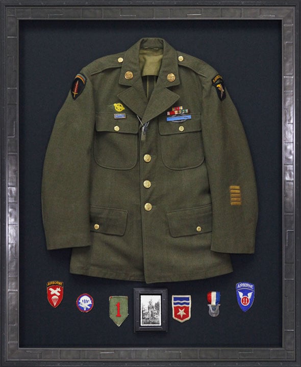 custom framed military jacket with patches on a dark mat Hall of Frames Arizona