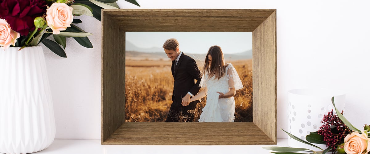 A brown tabletop frame with a couple's photo Hall of Frames Arizona