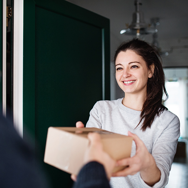 A box being delivered to a woman's door