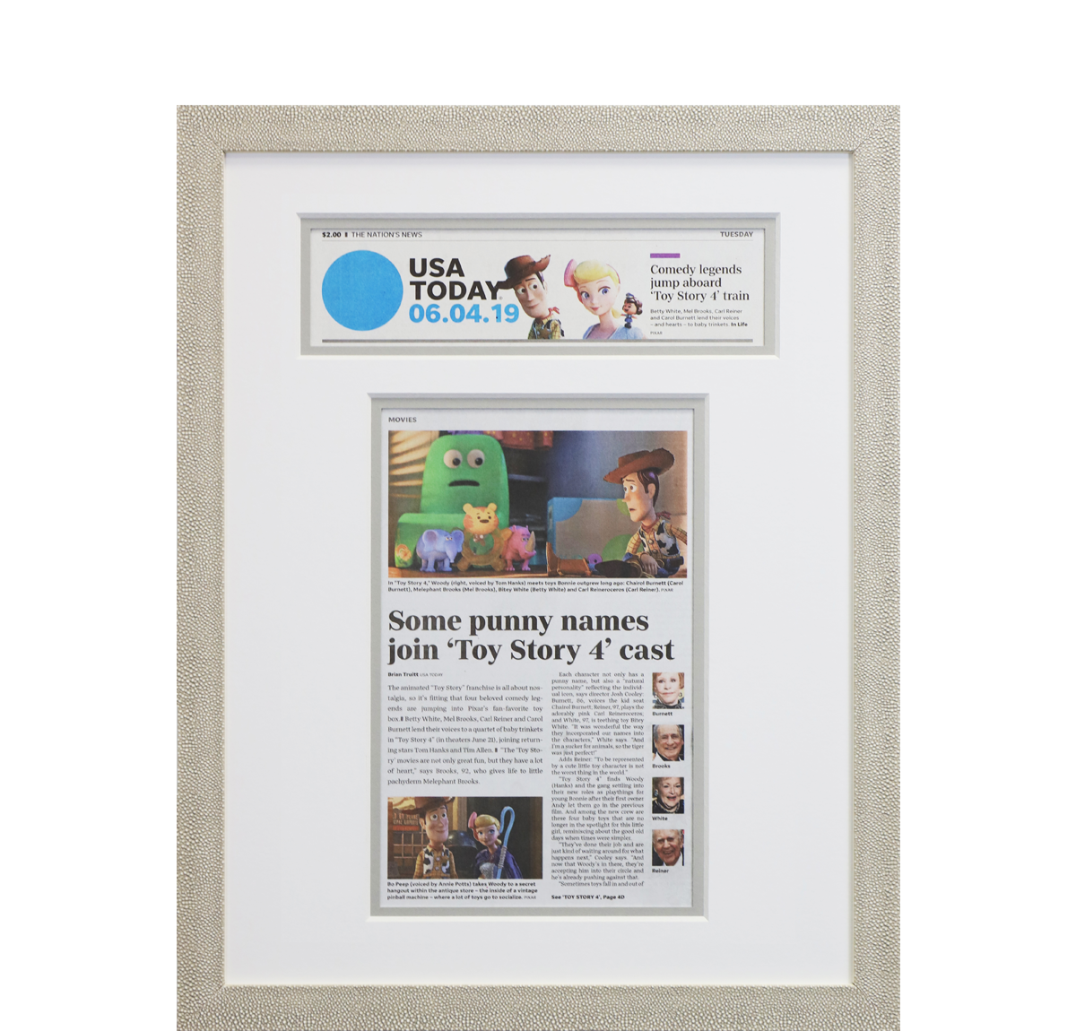 A photo of a custom framed newspaper article from USA Today with a custom headline cutout from Hall of Frames.