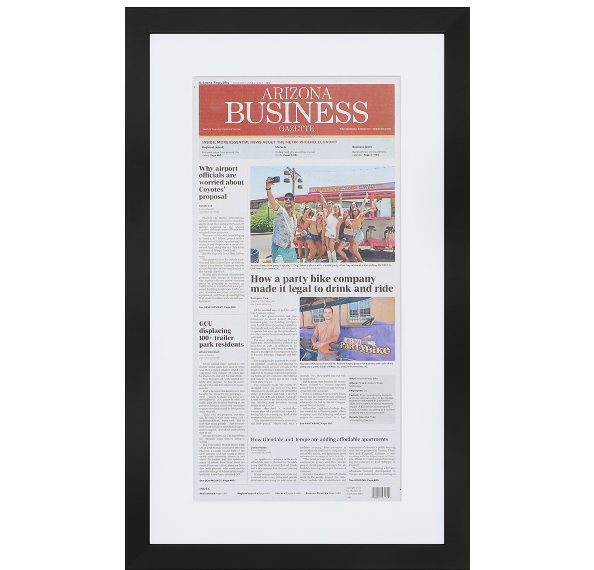 A photo of a custom framed newspaper article by Hall of Frames.