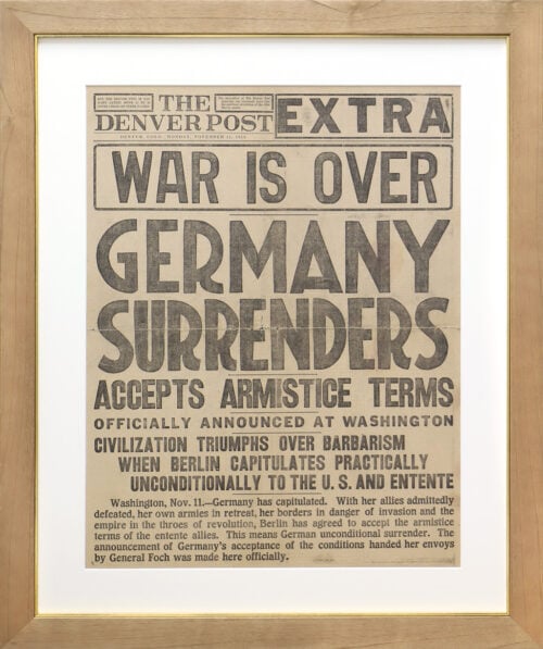 A photo of a custom framed newspaper article in the Denver Post about WWII ending from Hall of Frames.