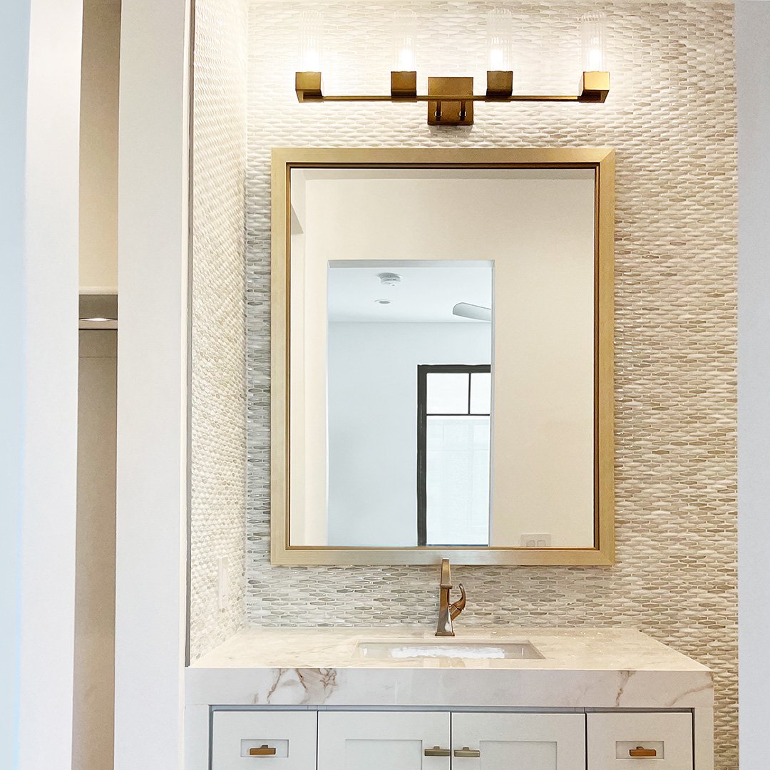 Photo of a custom framed mirror over a single sink by Hall of Frames