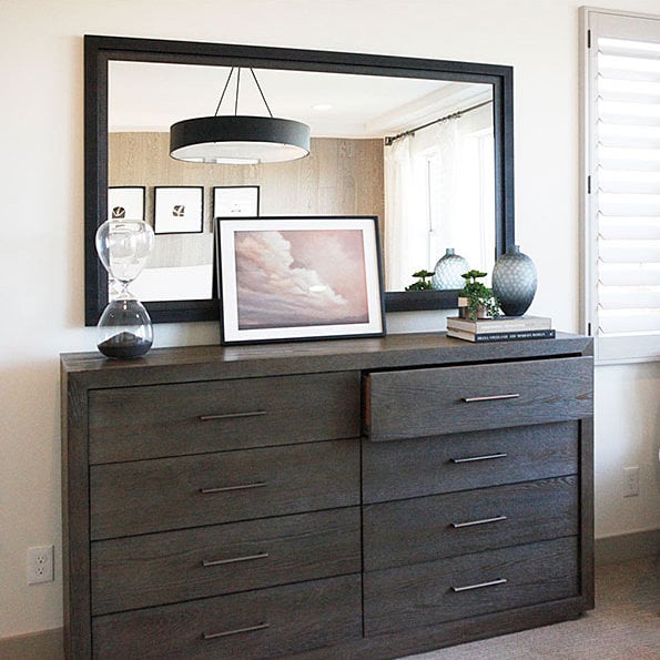 Photo of a custom framed mirror above a dresser