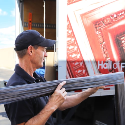 A photo of a Hall of Frames professional moving a frame