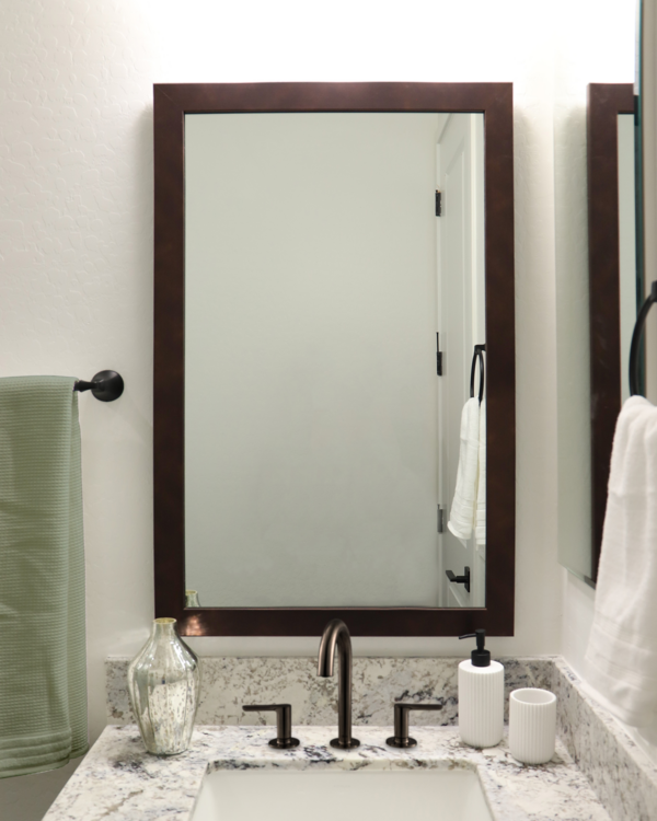 Bronze Storm Framed Mirror in Traditional Bathroom with Single Vanity and Bronze Hardware