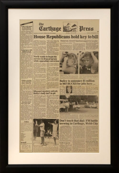 A photo of a custom framed online Carthage Press article by Hall of Frames