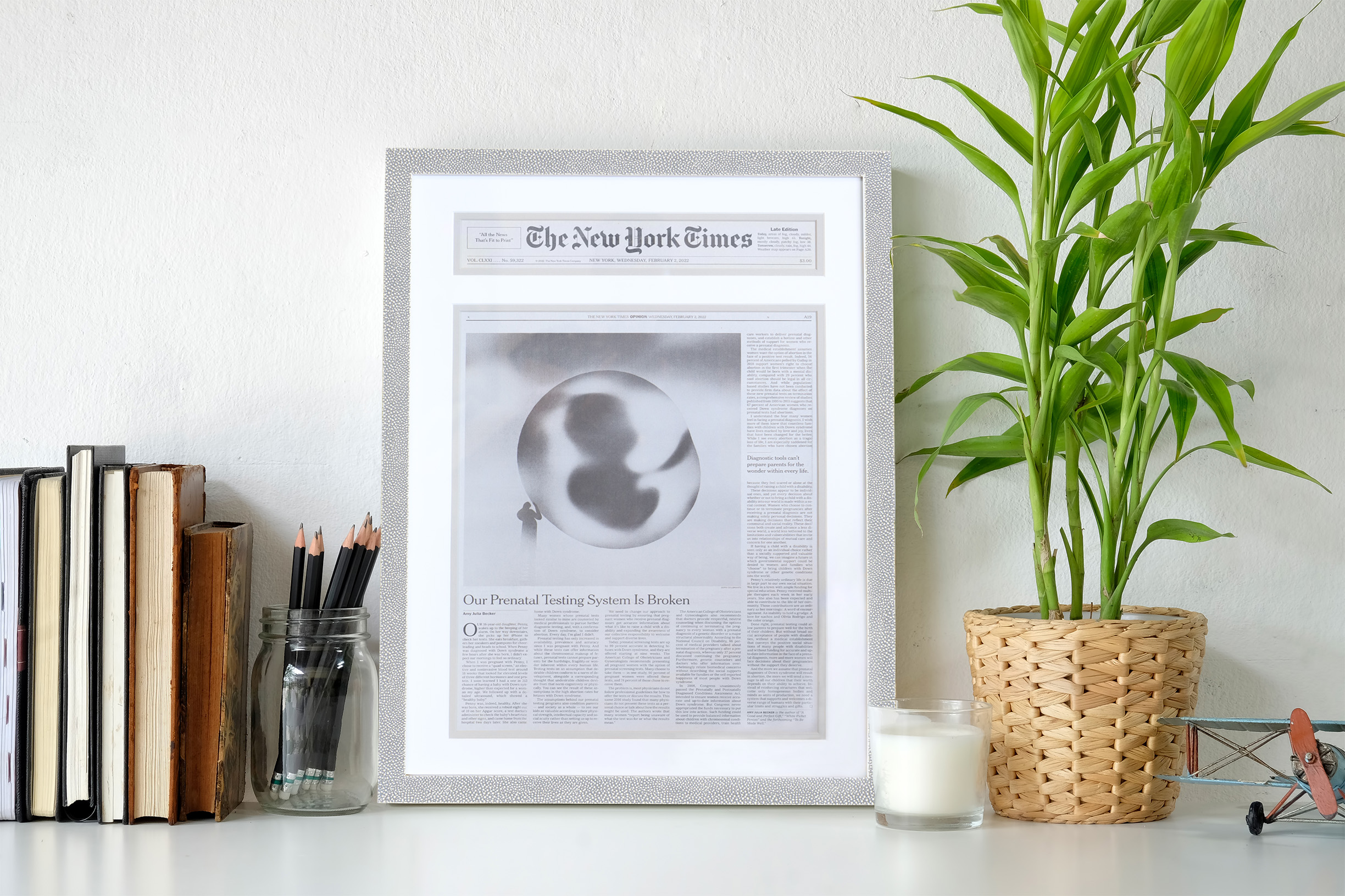A photo of desk with a custom framed NY Times Article by Hall of Frames