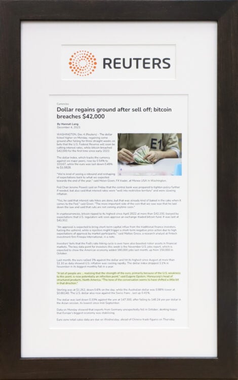 A photo of of a custom framed headline cutout Reuters newspaper aticle by Hall of Frames