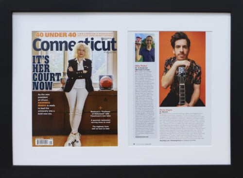 A photo of custom framed 40 under 40 Connecticut Magazine article by Hall of Frames