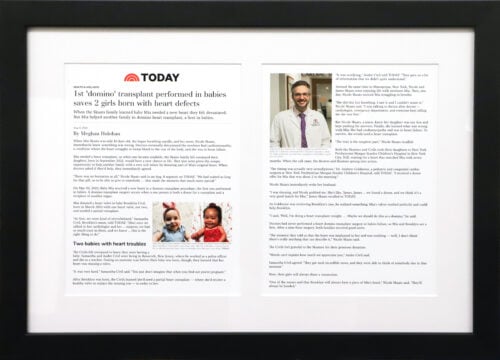A photo of a custom framed framed USA Today 2 page spread online article framed by Hall of Frames