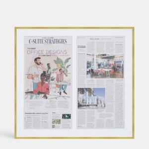 A custom framed newspaper two page spread article in a thin modern gold brass from Hall of Frames.