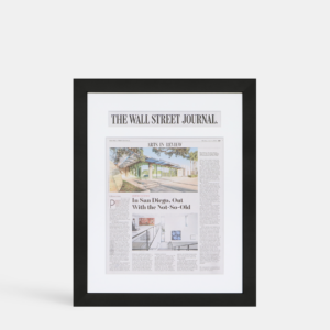 A photo of a custom framed newspaper article  with a custom headline cutout from Hall of Frames.
