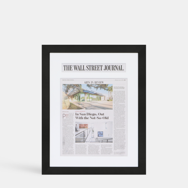 A photo of a custom framed newspaper article  with a custom headline cutout from Hall of Frames.