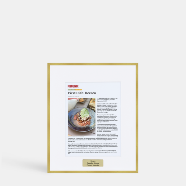 A photo of a custom framed digital article with an engraved plate in a thin modern gold brass by Hall of Frames.