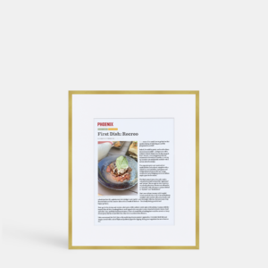 A photo of a custom framed digital article in a thin modern gold brass by Hall of Frames.