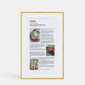 A photo of a custom framed large single page digital article in a thin modern gold brass by Hall of Frames.