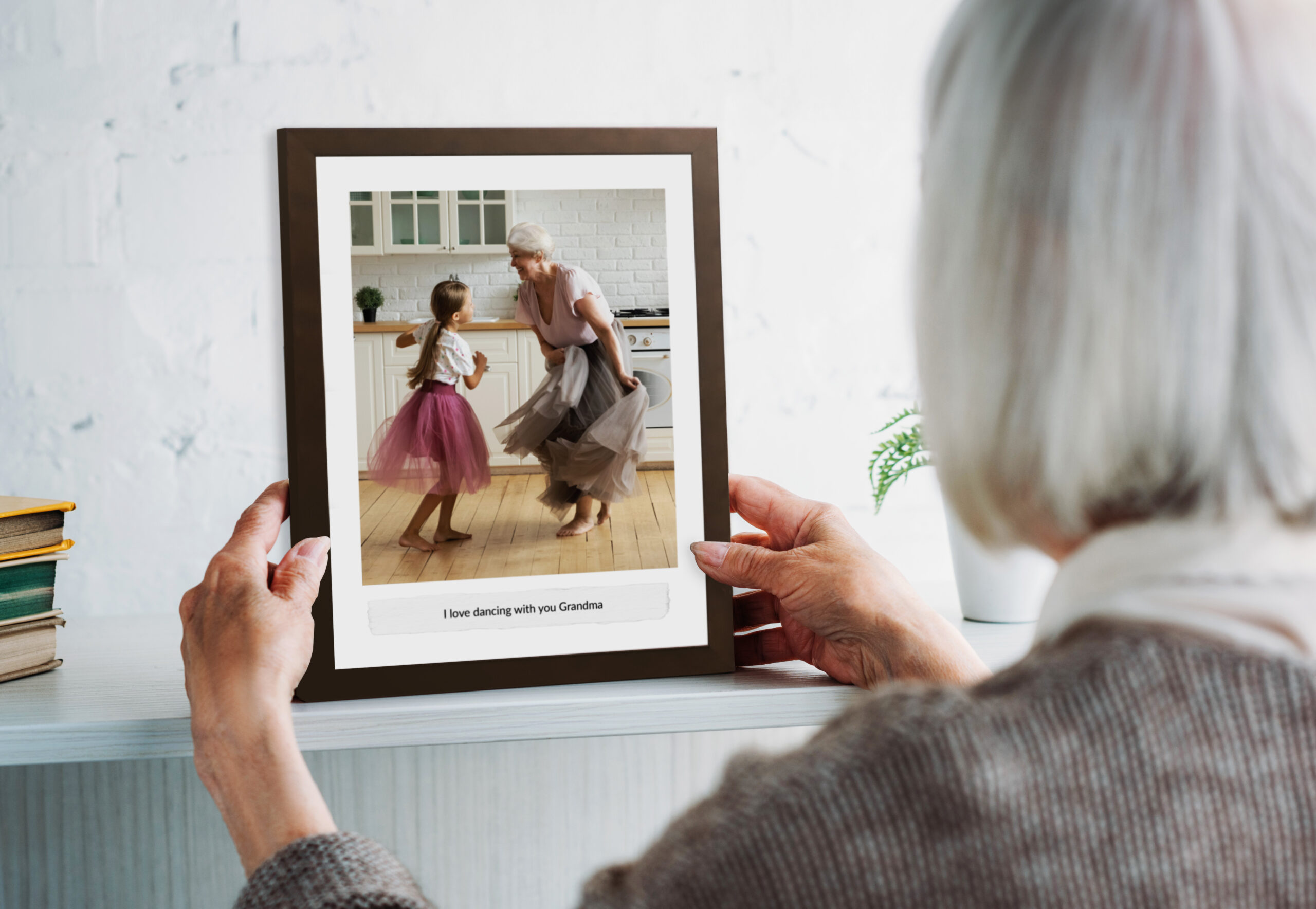 A photo of a elderly woman holding a Love Letter frame by Hall of Frames.