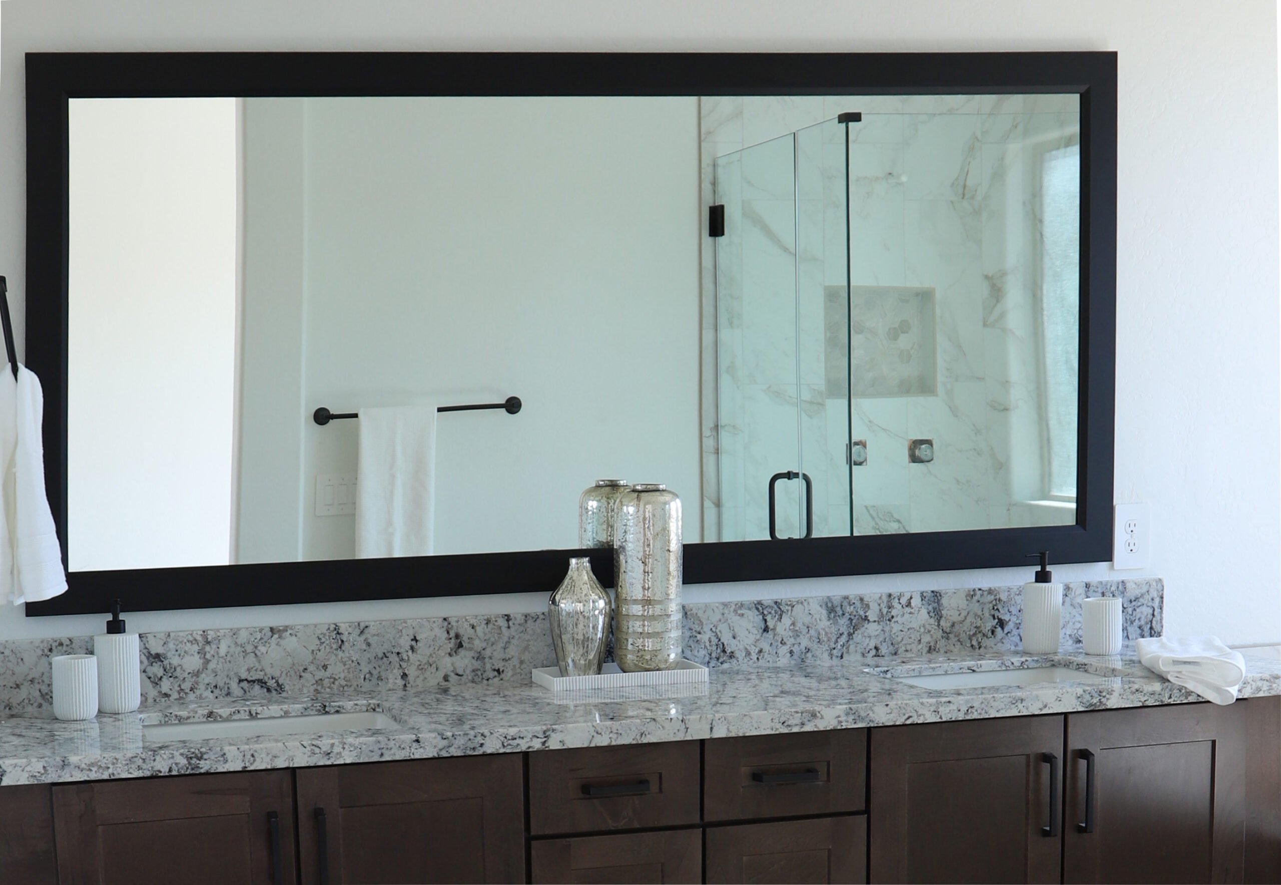 A photo of a double vanity bathroom custom framed mirror by Hall of Frames.