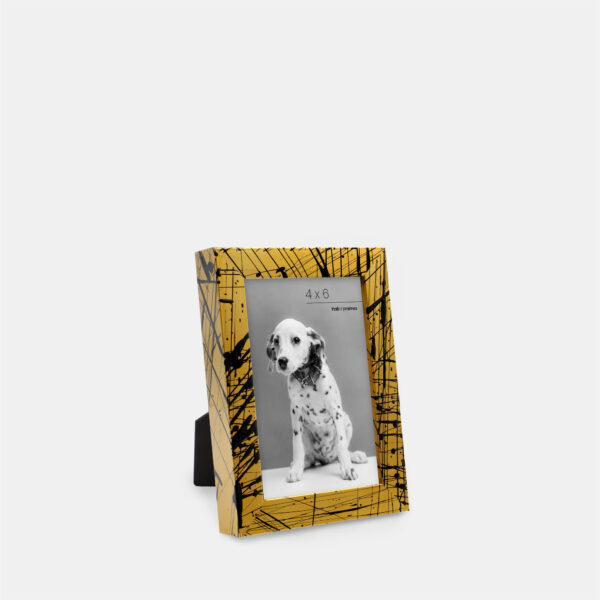 A paint splatter frame in the color Oro Drip featuring a photo of a Dalmatian puppy. 