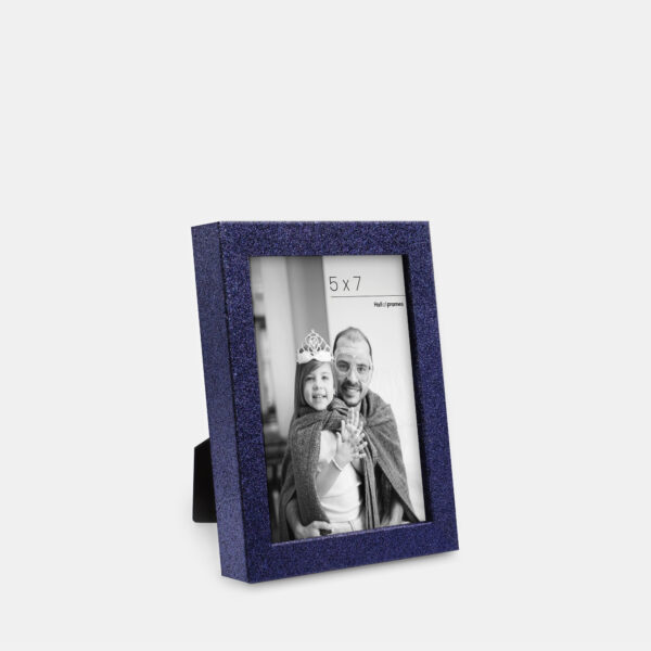 A cobalt colored sparkly, glitter frame containing a playful photo of a father and daughter.