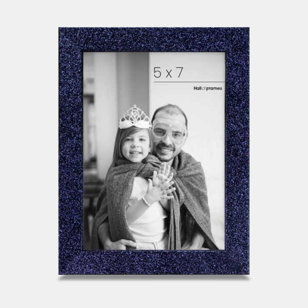 A cobalt colored sparkly, glitter frame containing a playful photo of a father and daughter.