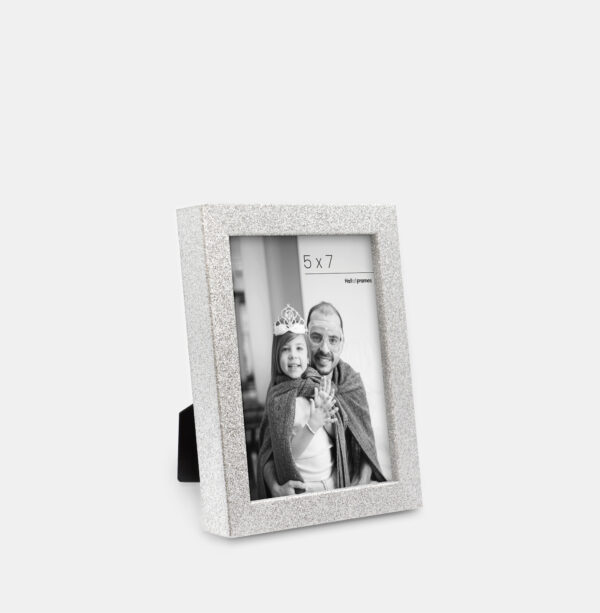 A silver colored sparkly, glitter frame containing a playful photo of a father and daughter.
