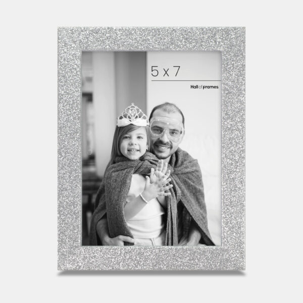 A silver colored sparkly, glitter frame containing a playful photo of a father and daughter.