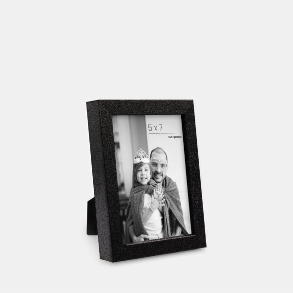 A midnight colored sparkly, glitter frame containing a playful photo of a father and daughter.