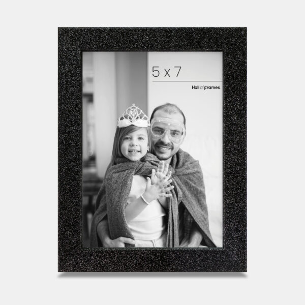 A midnight colored sparkly, glitter frame containing a playful photo of a father and daughter.