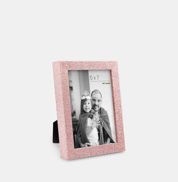 A rose colored sparkly, glitter frame containing a playful photo of a father and daughter.