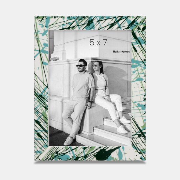 A paint splatter frame in the color Verde Mint featuring a modern, architectural photo of a couple. 