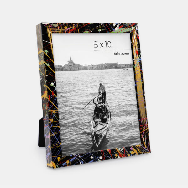 A paint splatter frame in the color Acro Mist featuring a photo of a couple in a gondola. 