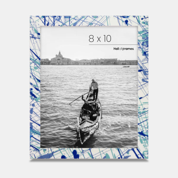 A paint splatter frame in the color Azure Flow featuring a photo of a couple in a gondola. 