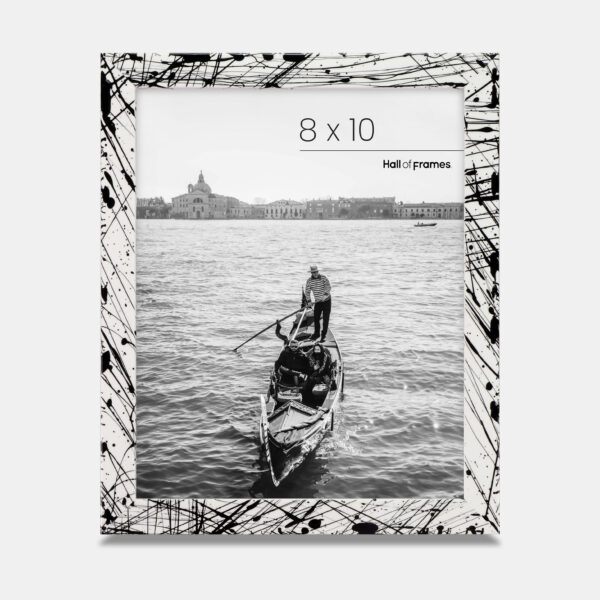 A paint splatter frame in the color Metro Fade featuring a photo of a couple in a gondola. 
