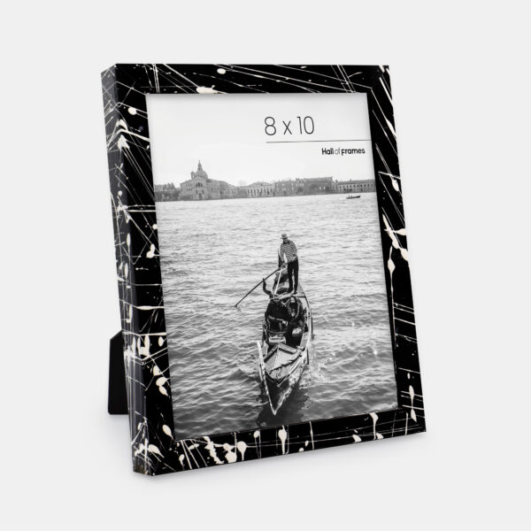 A paint splatter frame in the color Night Hush featuring a photo of a couple in a gondola. 