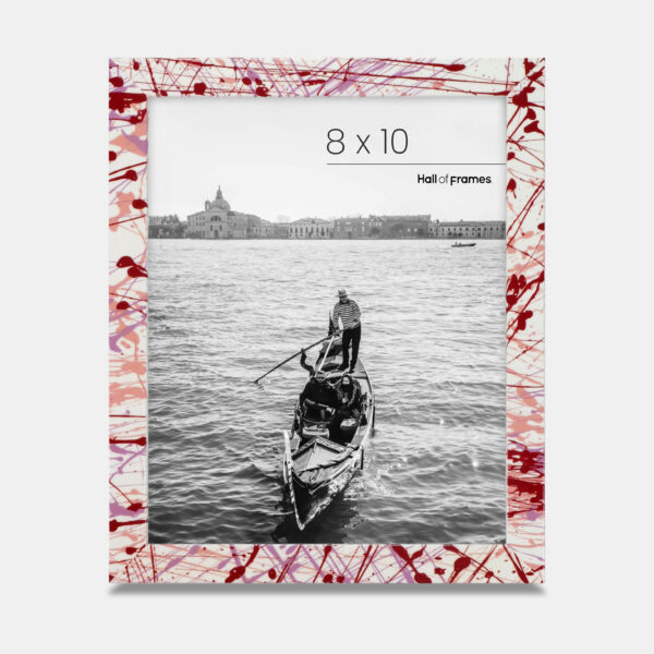A paint splatter frame in the color Rebel Rose featuring a photo of a couple in a gondola. 
