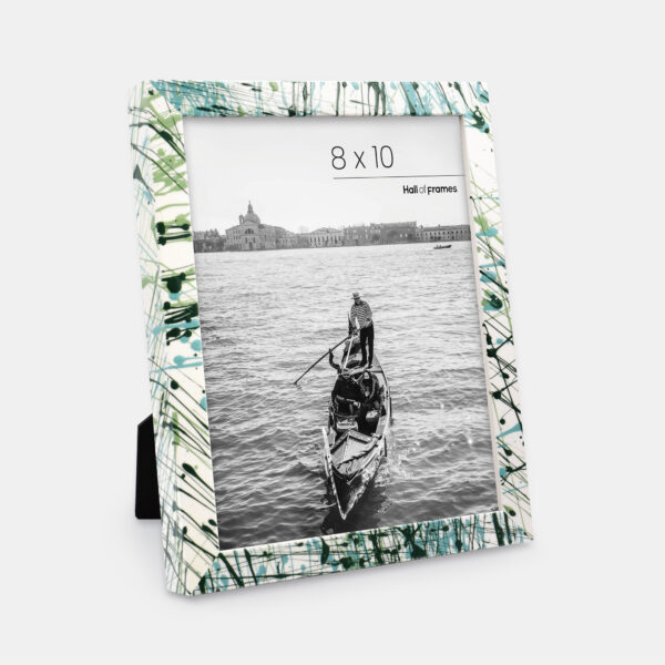 A paint splatter frame in the color Verde Mint featuring a photo of a couple in a gondola. 