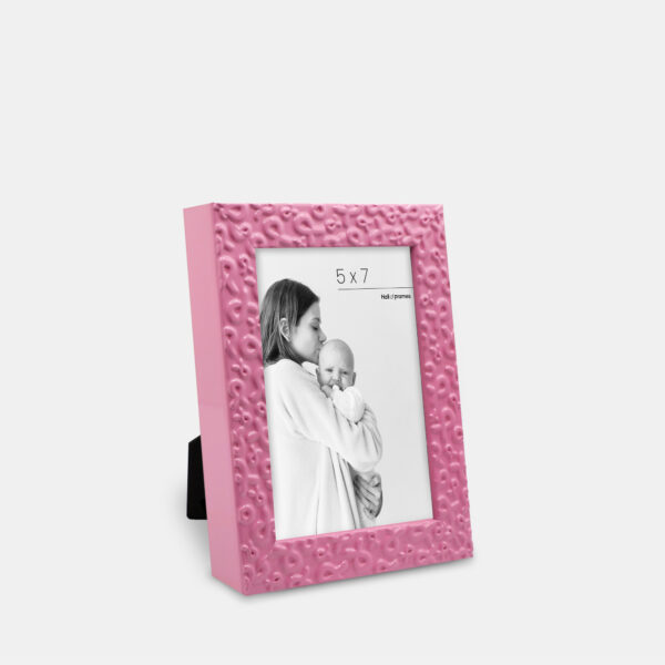 A pink frame featuring ribbons of strength serving a heartfelt tribute of love and support, bordering a photo with a mother and baby.