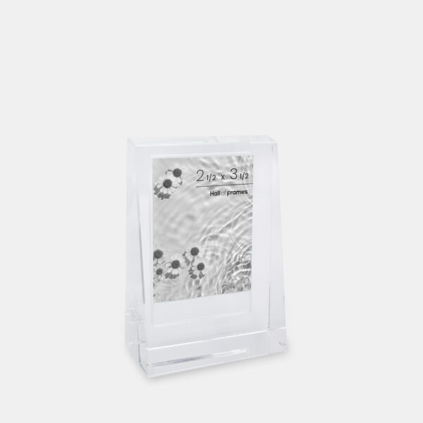 A 2.5x3.5 glass frame that features an angled wedge shape with a photo of flowers in a pond inside.