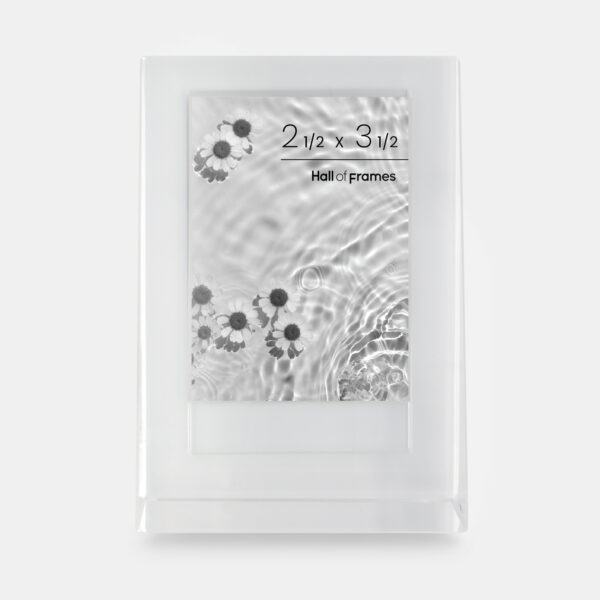 A 2.5x3.5 glass frame that features an angled wedge shape with a photo of flowers in a pond inside.