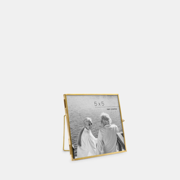 A 5x5 angled ultra-slim brass metal photo frame, crafted with sleek antique brass to frame any photo.