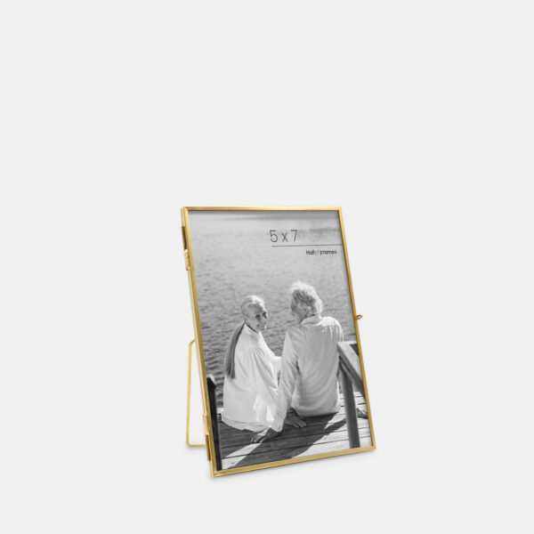 A 5x7 angled ultra-slim brass metal photo frame, crafted with sleek antique brass to frame any photo.