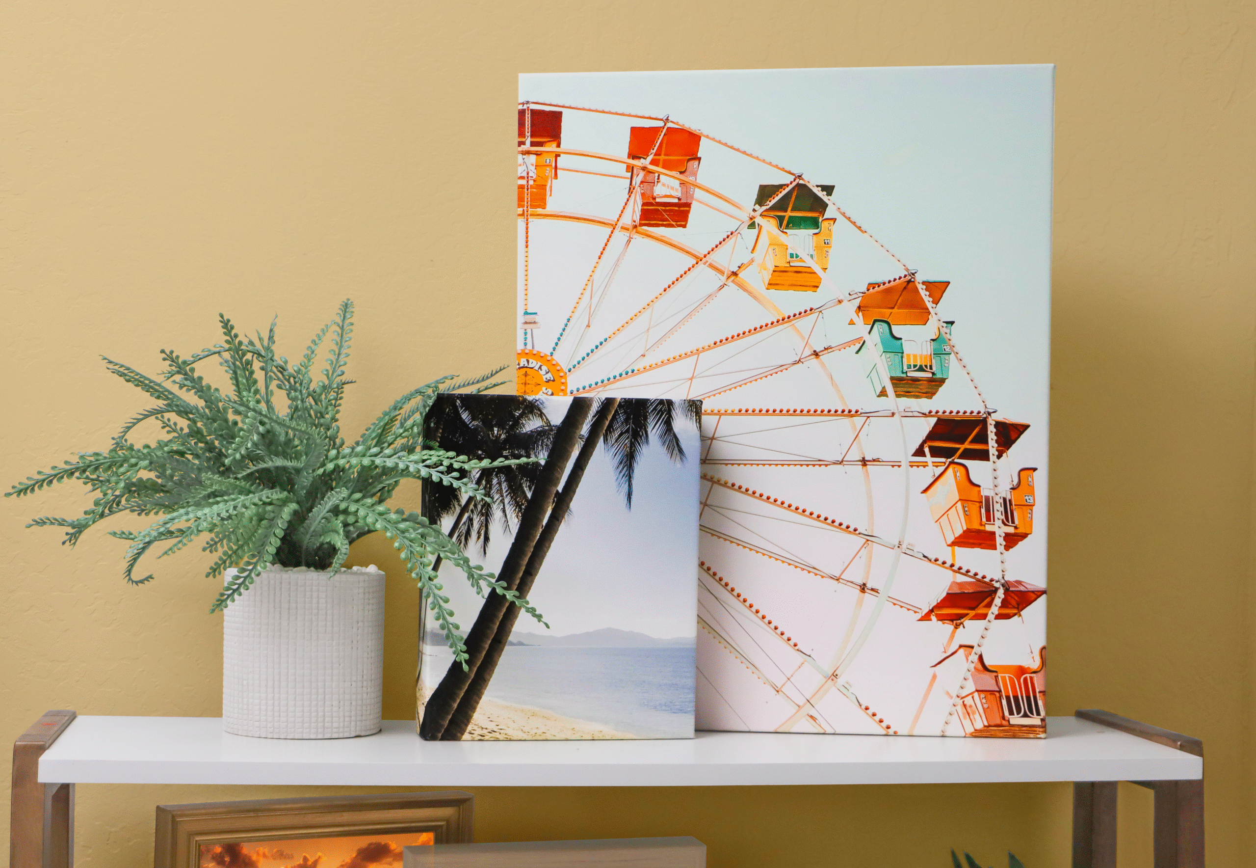 Scene with canvas prints of a beach scene and ferris wheel