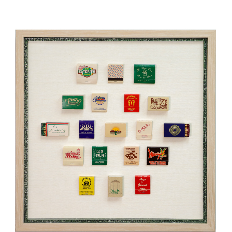 Framed matches with an arizona theme displayed on beige mat with green frame