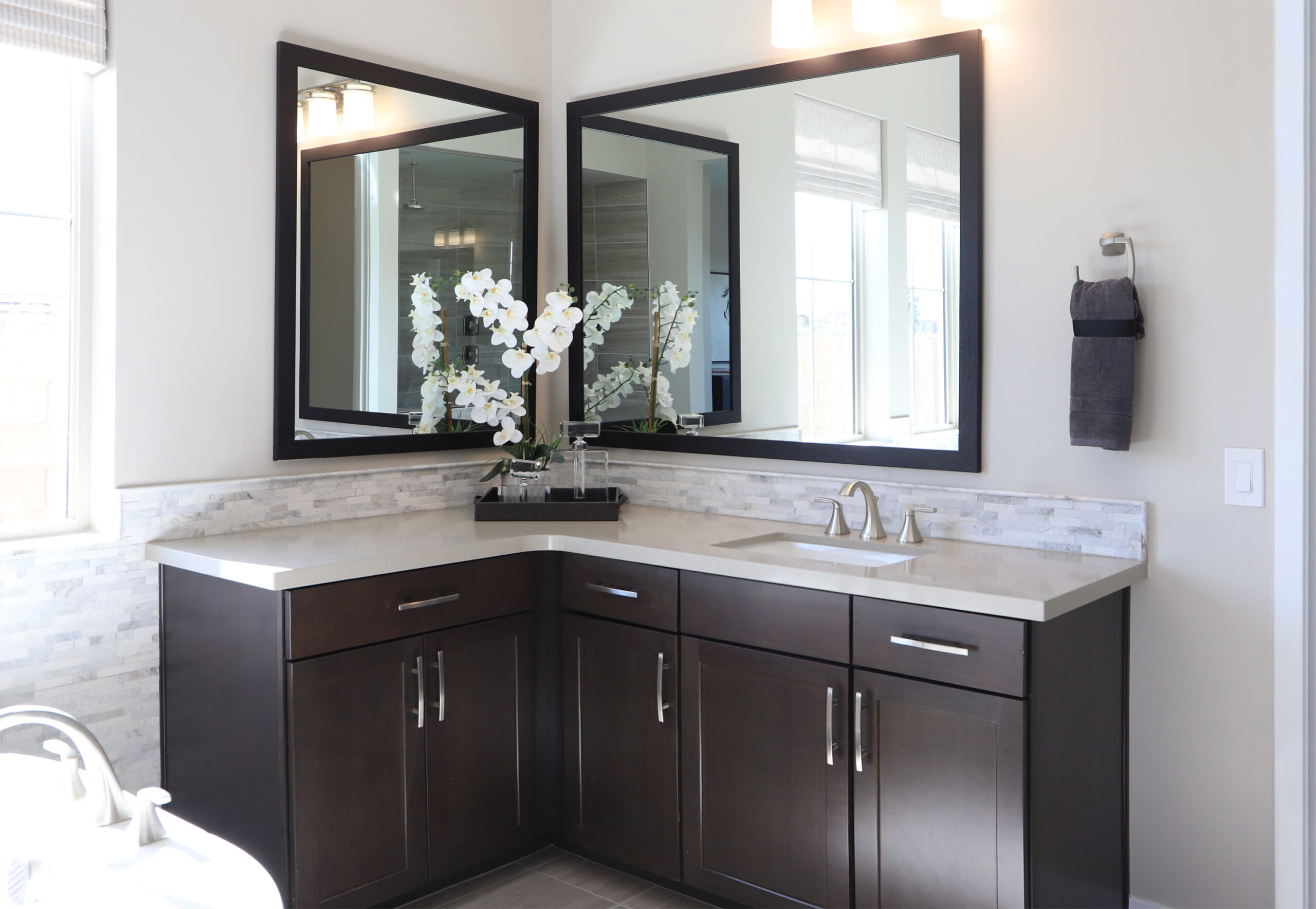photo of a scene with two mirrors in a bathroom